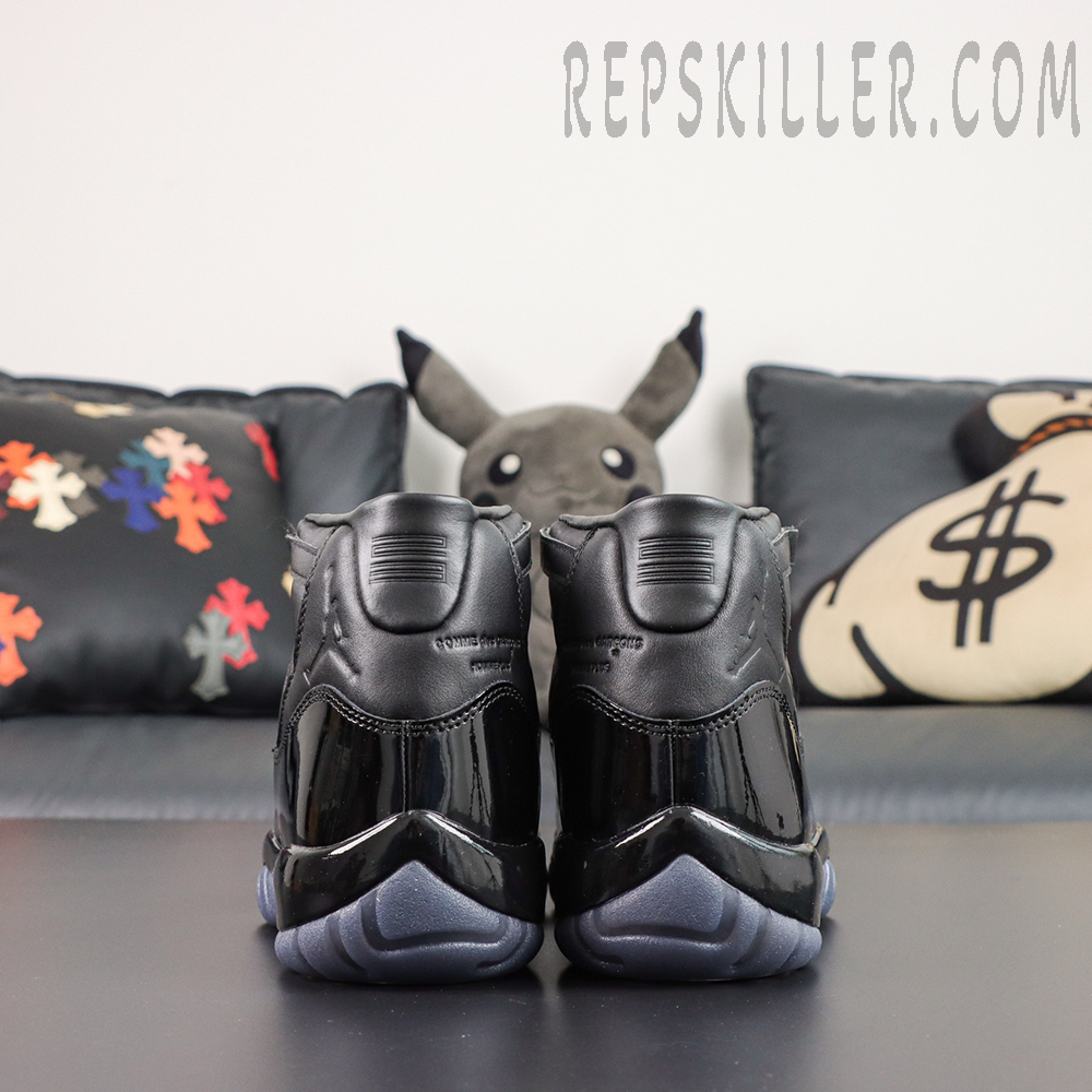 Comme des Garçons x Air Jordan 11 Retro ‘Black’ rear view featuring embossed Jumpman and collaboration details, glossy patent leather heels, and grey translucent outsoles