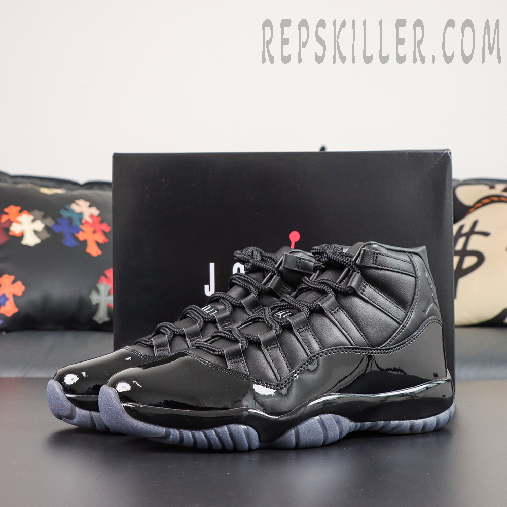 Comme des Garçons x Air Jordan 11 Retro ‘Black’ pair displayed with a black Jordan shoebox, featuring black leather uppers and glossy patent leather mudguards
