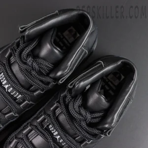 Comme des Garçons x Air Jordan 11 Retro ‘Black’ top close-up featuring black rope laces, padded tongues, leather lining, and collaborative tongue detailing