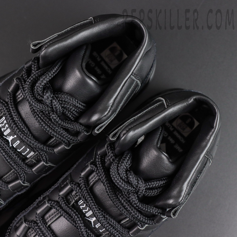 Comme des Garçons x Air Jordan 11 Retro ‘Black’ top close-up featuring black rope laces, padded tongues, leather lining, and collaborative tongue detailing