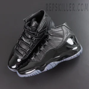 Comme des Garçons x Air Jordan 11 Retro ‘Black’ top angle view featuring black leather uppers, glossy patent leather mudguards, embossed Jumpman branding, and translucent grey outsoles