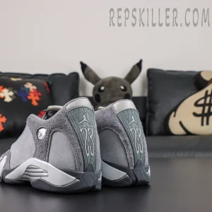 Air Jordan 14 Retro ‘Flint Grey’ rear angle view featuring a grey suede upper, Jumpman and 23 heel branding, and metallic silver midsole details