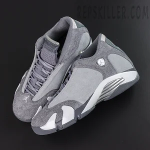 Air Jordan 14 Retro ‘Flint Grey’ top angle view featuring grey suede uppers, circular Jumpman badges, metallic silver midsoles, and dark grey outsoles