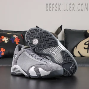 Air Jordan 14 Retro ‘Flint Grey’ outsole view featuring dark grey herringbone traction, a metallic silver midfoot section, and Jumpman branding