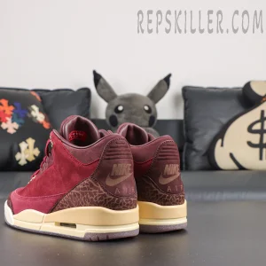 Air Jordan 3 Retro ‘Bin23’ rear angled view featuring burgundy suede construction, elephant print heel panels and cream midsole