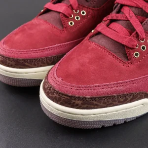 Air Jordan 3 Retro ‘Bin23’ toe box close-up featuring burgundy suede panels, brown elephant print mudguard and detailed stitching