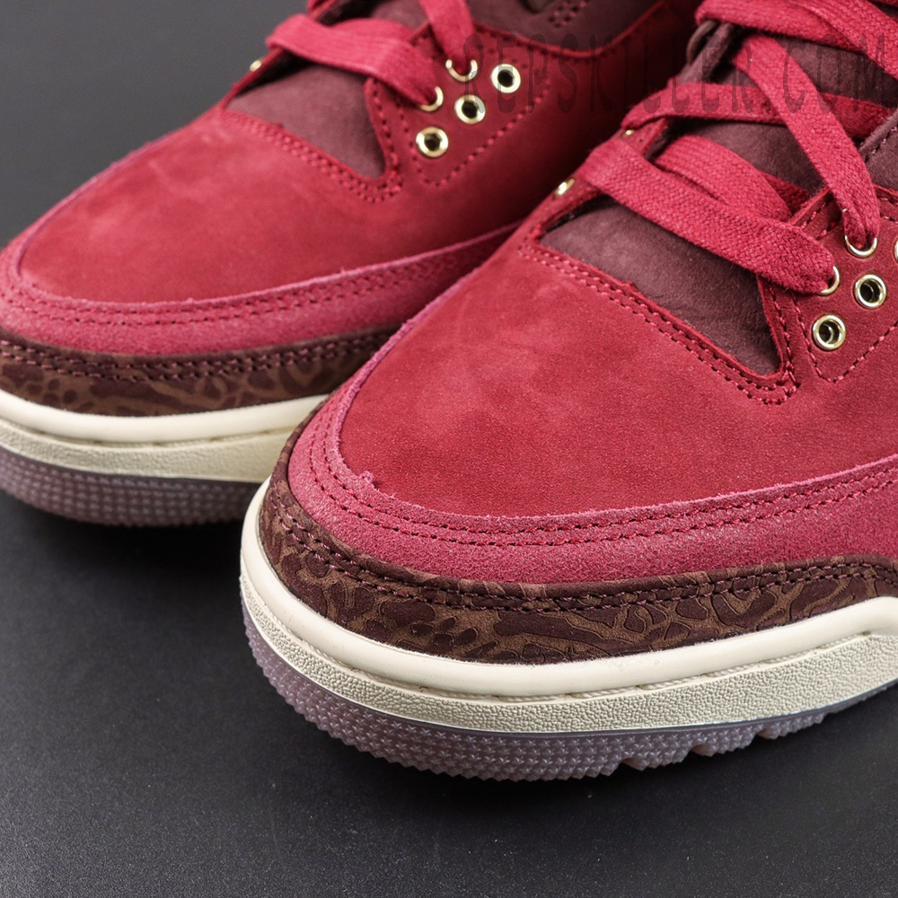 Air Jordan 3 Retro ‘Bin23’ toe box close-up featuring burgundy suede panels, brown elephant print mudguard and detailed stitching