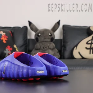 Nike Mind 001 AMP ‘Indigo Burst’ rear angle view featuring an indigo foam body, red collar accents, metallic Nike heel branding, and red outsole nodes