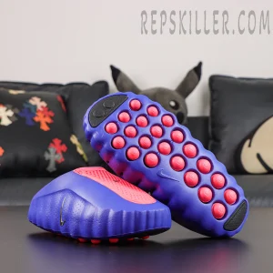 Nike Mind 001 AMP ‘Indigo Burst’ outsole view featuring multiple bright red foam nodes, indigo sole construction, black rubber traction sections, and Nike Swoosh