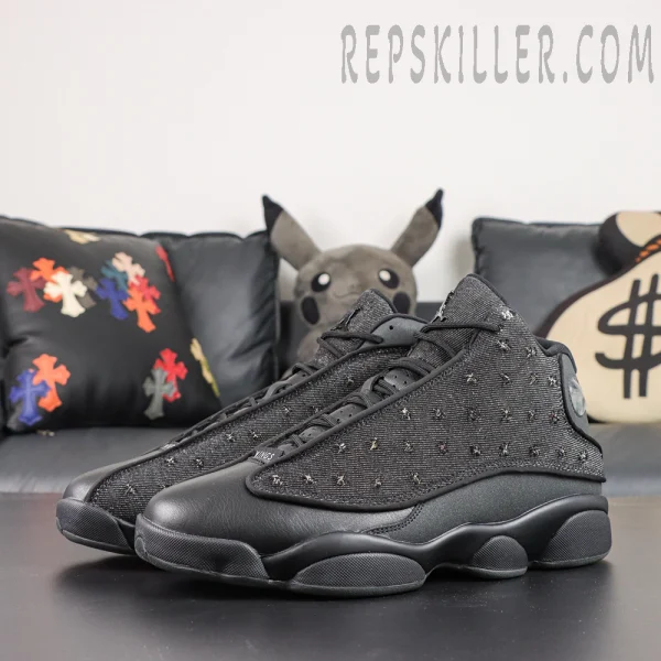Air Jordan 13 ‘Wings’ 2026 front three-quarter pair view featuring black leather toe panels, dark woven uppers with embroidered details, and the classic AJ13 silhouette