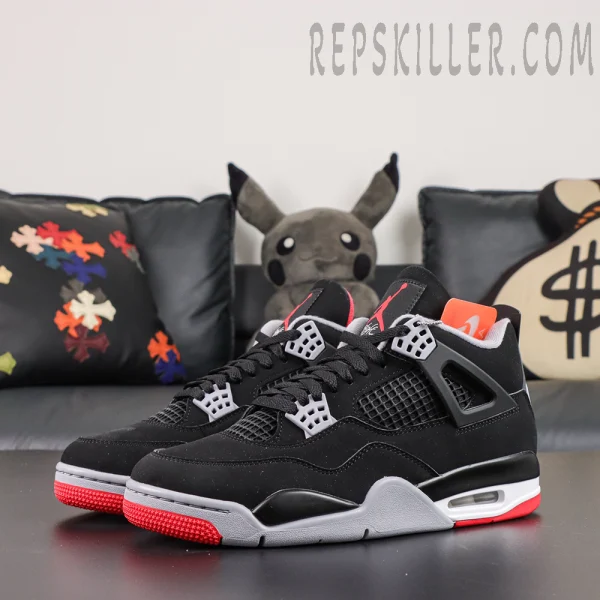 Air Jordan 4 Retro OG ‘Bred’ 2026 front angle view featuring black uppers, grey lace wings, mesh panels, red Jumpman tongue logos, and red outsole accents